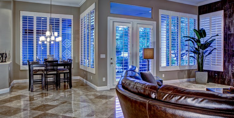 Honolulu great room with white shutters and tile floor.